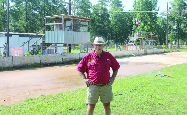 Richard Loveless is pictured as the new sprinkler system waters down the track at Turkey Creek. He is leasing the track from the village on a yearly basis with hopes of expansion. (Gazette photo by Tony Marks)