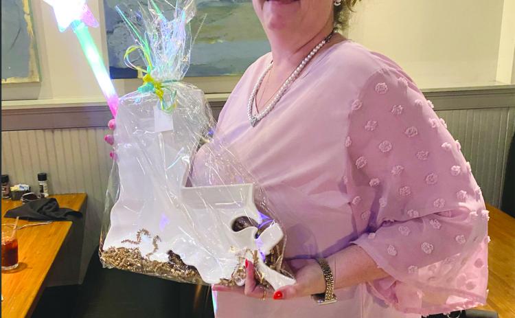 Tonya Soileau, of Pine Prairie High School, shows off a gift for being recognized as a support employee of the year state finalist. (Photo courtesy of Grace Sibley)