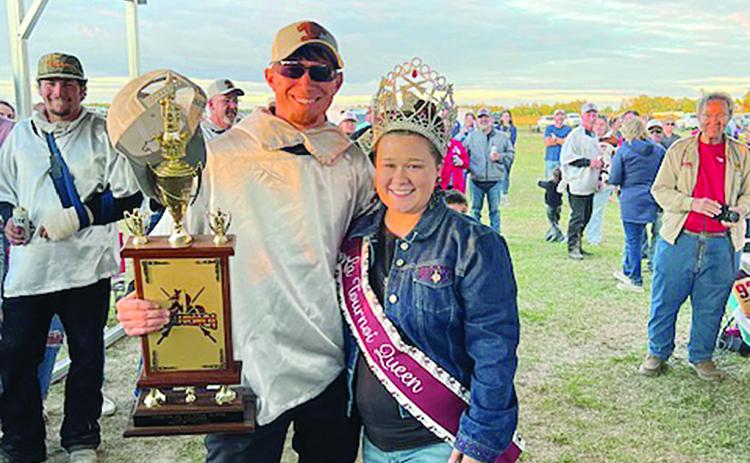 Tournoi champion Marcus Guillory (left) is presented his First  Place trophy by Tournoi Queen Shelbi Guidry. (Gazette photo by Tony Marks)