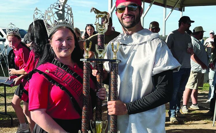 Tournoi champion Eric Guillory accepts his trophy from Louisiana Tournoi Queen Courtlyn Gremillion.
