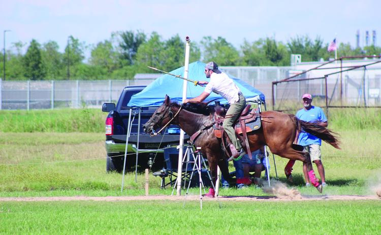 Eric Guillory is pictured as he collects one of the seven Tournoi rings that represent the seven enemies of cotton during the qualifications held Sunday, September 13. (Gazette photo by Tony Marks)