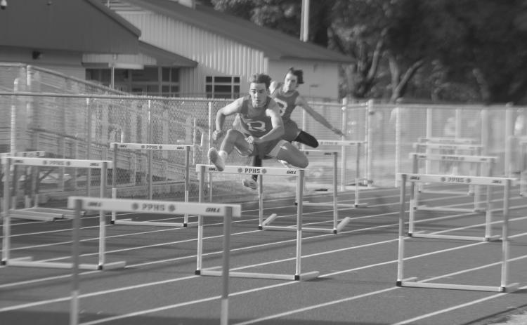 Tyler Newman and Landon Fontenot, both of Basile, are pictured as they compete in the 110m hurdles during the parish track meet held at Pine Prairie High School. (Gazette photo by Rhett Manuel)