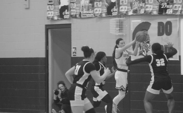 Bre Ardoin (24) keeps the basketball from going out of bounds for Sacred Heart in the finals of the girls’ Turkey Tournament against Jena. The Lady Trojans were the runner-up after a 64-37 loss to the Lady Giants. (Gazette photo by Tony Marks)