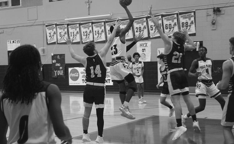 Ville Platte’s Sage Papillion (23) goes up for a basket while being defended by Sacred Heart’s Keegan McIntosh (14) and Austin Darbonne (21). (Gazette photo by Tony Marks)