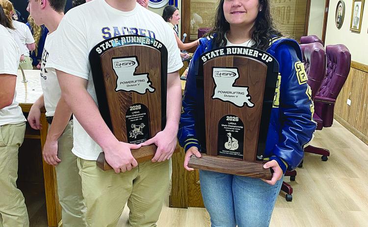 Sam LaFleur (left) and Haylee Dupre (right) are pictured as they display the state runner-up trophies in powerlifting. Both are senior captains for this year’s Sacred Heart teams. (Photo courtesy of Misty Parker)