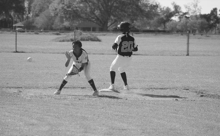 Pine Prairie’s Sydney Fontenot (20) advances to second base ahead of a throw to Ville Platte’s Janiah Leday. (Gazette photo by Tony Marks)