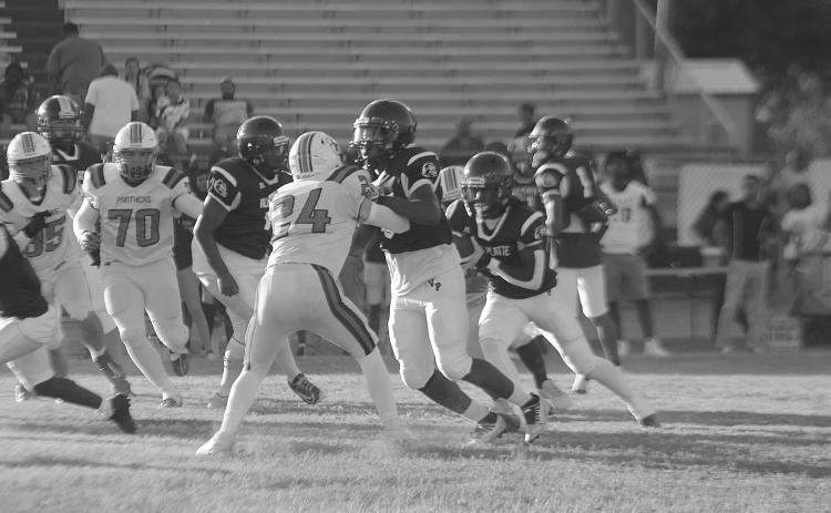 Darius Chagois (8) provides a block to allow Latelldrick Prejean (3) to pick up positive yardage for Ville Platte against Pine Prairie. (Gazette photo by Tony Marks)