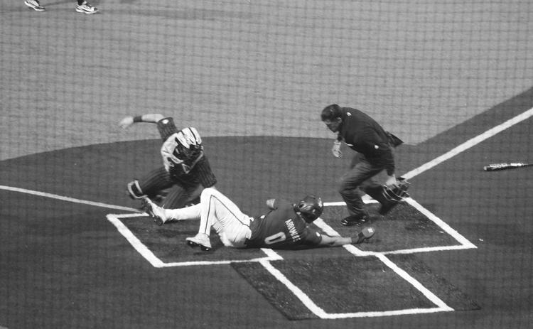 Cade Arrambide (0) slides across home plate ahead of a tag from the Vanderbilt catcher in Game 1 of LSU’s conference opening series against the Commodores on Friday, March 13. (Gazette photo by Tony Marks)
