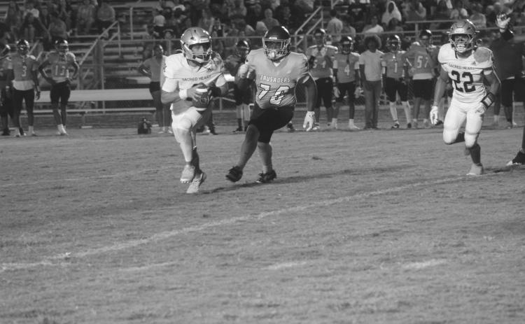 Ellis Fusilier (2) looks to find positive yards for his Sacred Heart Trojans in a loss to Westminster Christian Academy. (Gazette photo by Tony Marks)