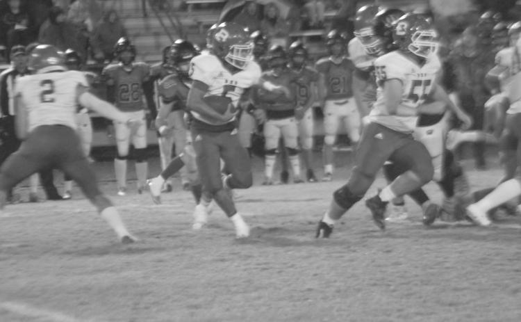 Bryan Hardy (5) looks to follow blocker Wyatt Bertrand (55) for a big gain in Basile’s playoff loss to Welsh. (Gazette photo by Rhett Manuel)