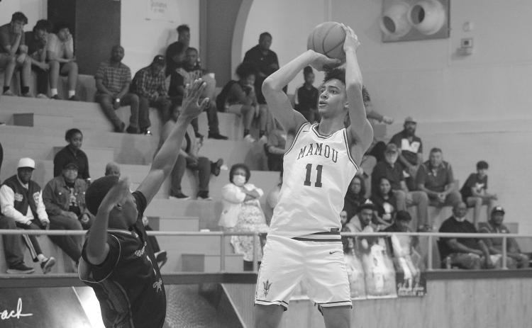 Braxton Ardoin (11) scores a goal for Mamou in its playoff-opening win against Winnfield. He led the Green Demons with 28 points in their 68-50 win. (Gazette photo by Tony Marks)