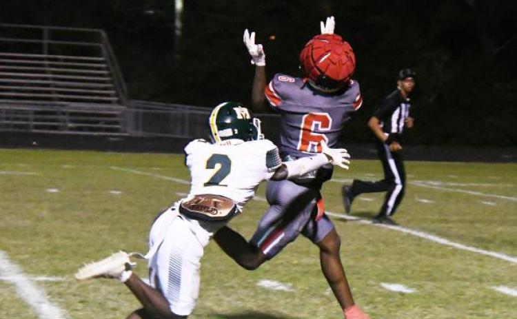 Kevin Jason (2) attempts to make a tackle on Abbeville’s Jacolby Campbell (6). (Photo courtesy of The Abbeville Meridional)
