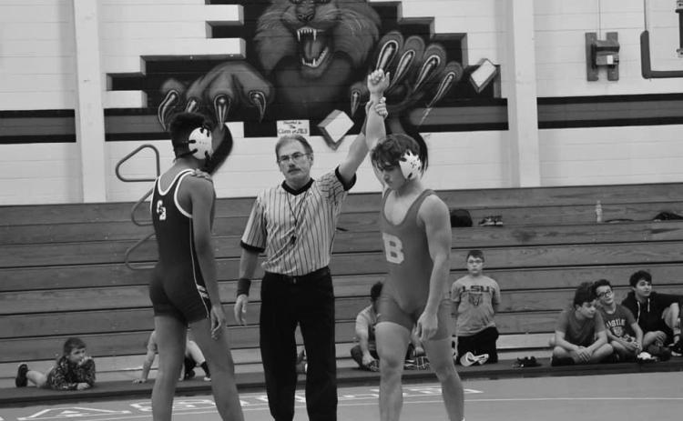 Andre Johnson is declared the winner at 138 pounds.  He was a state runnerup last year, and although a football player, was one of the few pigskin team members to wear a singlet in the opening wrestling action last week. (Photo provided)