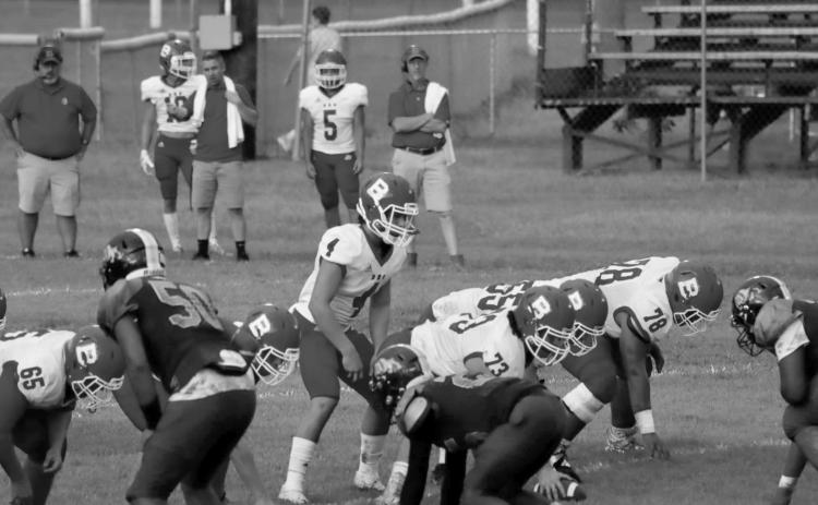 (At left) Bearcat quarterback Luc Johnson (4) lines up behind his center Christian Bergeron (73) in a game against Ville Platte earlier this season. Other identifiable Bearcats visible on the line are (from left) Emory LeJeune (65), Wyatt Bertrand (55), and Da’Shawn Randell (78). (Photo by Nikki Johnson)