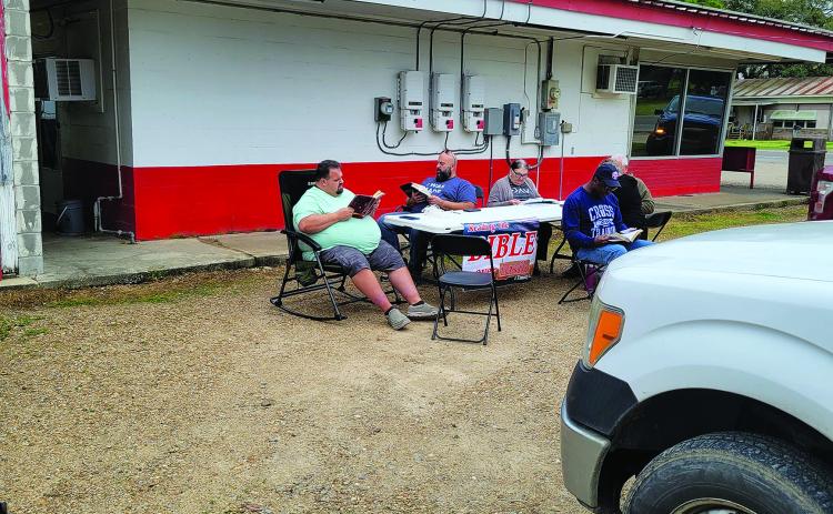 The parking lot of Chunkie’s Drive-In was one of the twelve posts where the Bible was read by 70 locals on March 9. Some of those taking part are shown above.