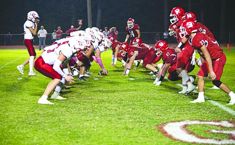 RED AND WHITE VS. RED AND WHITE - The Basile Bearcat defense (at right) lines up against the Port Barre Red Devils in last week’s BHS Homecoming football game. (Photo by Tonya Ortego)
