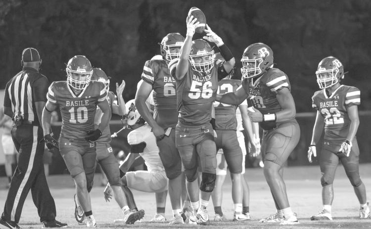 INTERCEPTION - Basile’s William Ashford (56) and several of his teammates celebrate an interception during a recent Bearcat game. Other BHS players pictured  are Carter Darbonne (10), Jack Comeaux (66), Zachary Mason (70), and Logan Bergeron (22). (Photo by Lanie LeJeune)