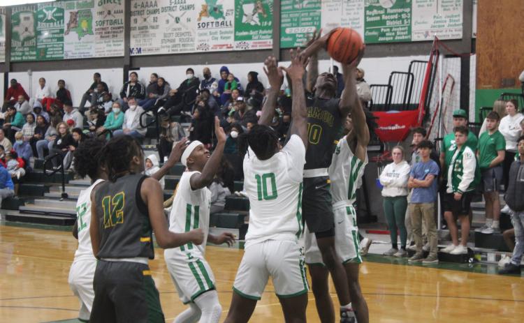 Mamou’s Tyrian Broussard (10) fights for a bucket in the Green Demons’ loss to Eunice, 72-59. (Gazette photo by Rhett Manuel)