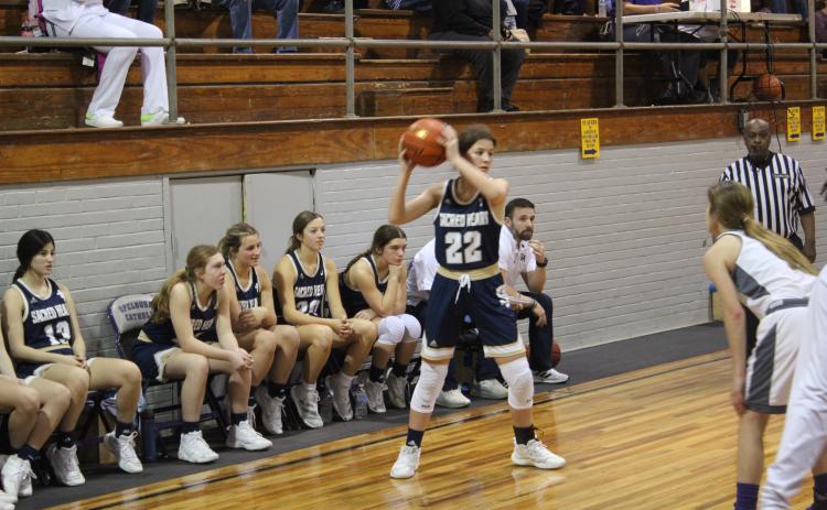 Kali Shiver (22) sets up a play for her Lady Trojans in Sacred Heart’s 47-46 road loss to Opelousas Catholic Tuesday night. (Gazette photo by Rhett Manuel)