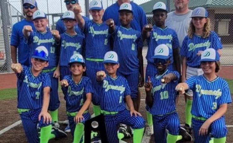 Led by head coach Jody Guillory and assistants Nicky Miller, Matt Perron and James “Scooby” Longino, Mamou travel baseball team DYNASTY recently won the USSSA World Series in Lake Charles on June 23-26. Pictured in no particular order are players Brogan Longino, Terry Vidrine, Layne Gremillion, Tae Tison, Frankie Thomas, Braxton Woodard, Grant Guillory, Oliver Perron, Brayden Perron, Mari Edwards and Bailey Miller. (Photo courtesy Cora Gremillion)